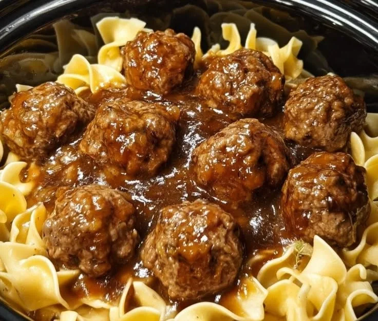 Amish meatball noodles served in a bowl with herbs and spices