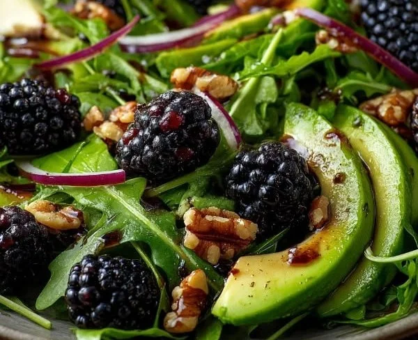 A vibrant Blackberry Avocado Arugula Salad with bright colors and fresh ingredients.