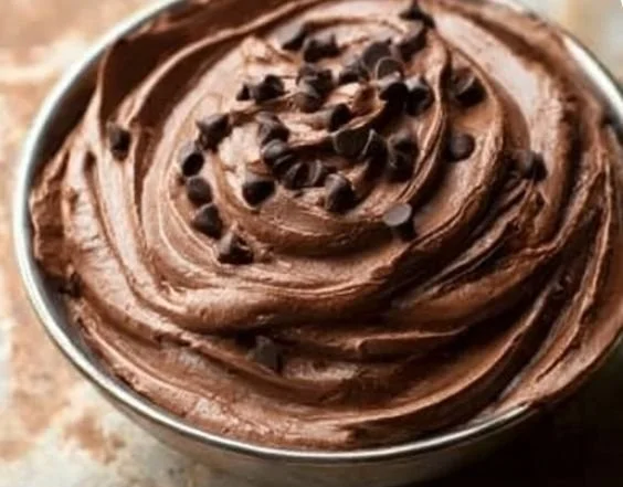 Creamy brownie dip served in a bowl with chocolate sprinkles and graham crackers