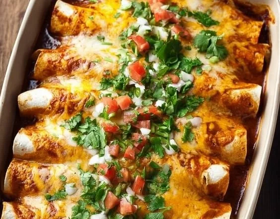Delicious chicken enchiladas topped with cheese and served with salsa