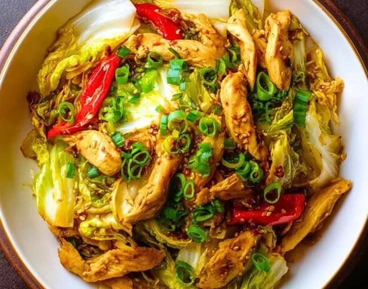 Delicious chicken cabbage stir-fry served in a bowl with vibrant vegetables.