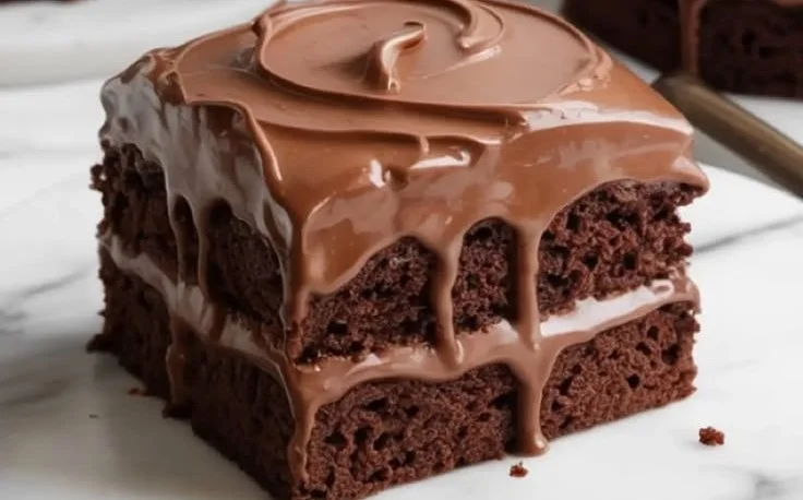 Delicious Chocolate Three Milks Cake topped with rich chocolate frosting.