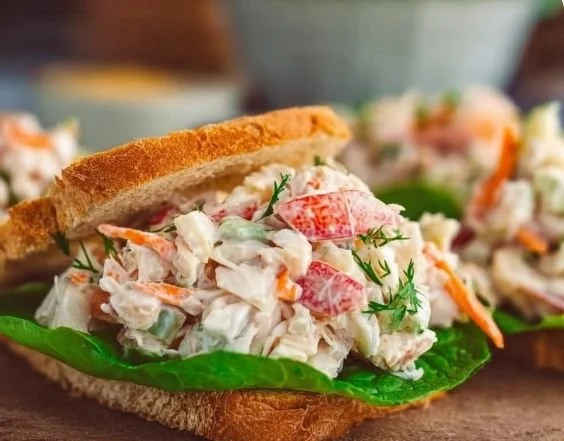 Delicious crab salad sandwich with fresh ingredients served on a plate.