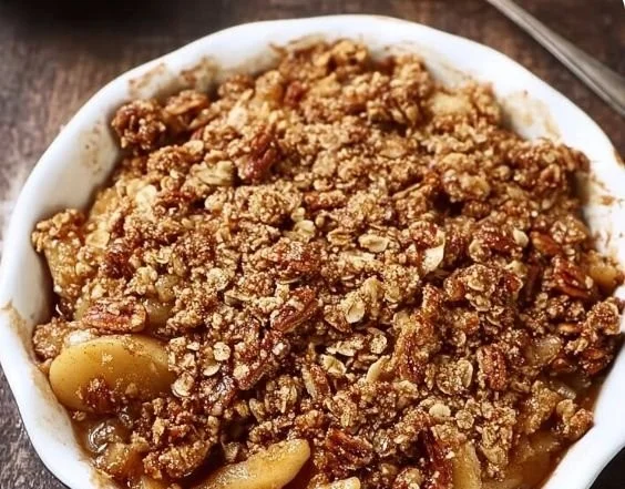 Healthy apple crisp with oatmeal pecan topping served in a bowl