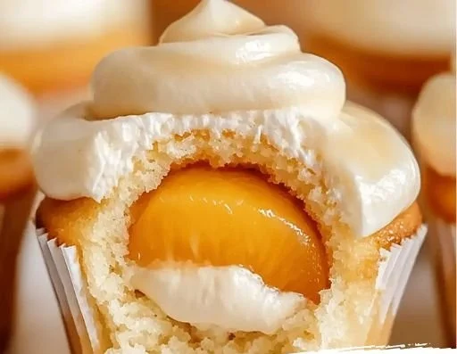 Honey Peach Cream Cheese Cupcakes topped with fresh peaches and creamy frosting