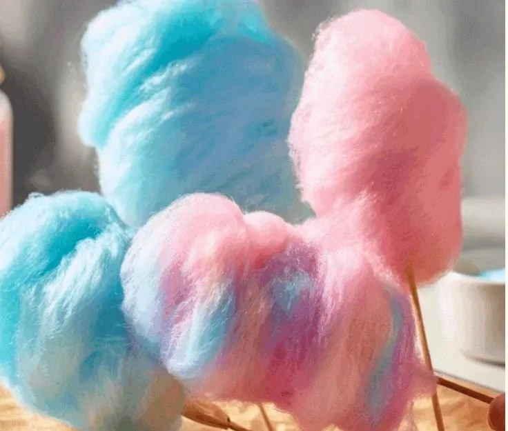 A colorful display of homemade cotton candy in various flavors and sizes.