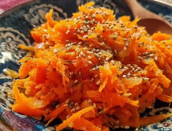 Japanese carrot ginger dressing in a bowl with fresh vegetables