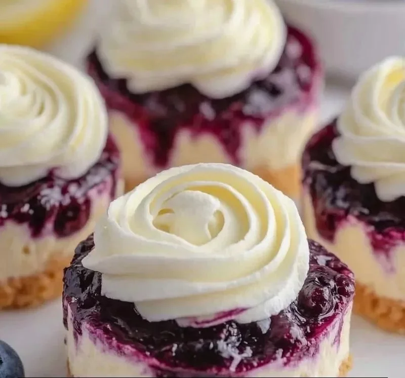 Mini lemon blueberry cheesecakes on a dessert platter