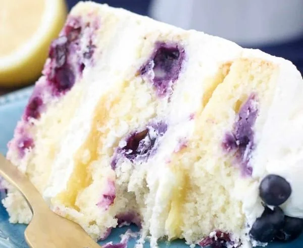 Lemon Blueberry Cake topped with blueberries and lemon zest