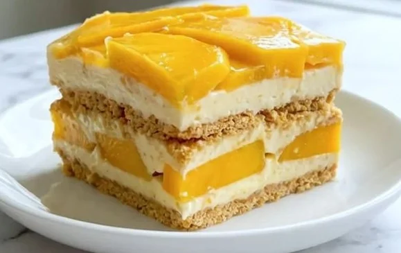 Delicious Mango Float dessert layered with mango, cream, and graham crackers