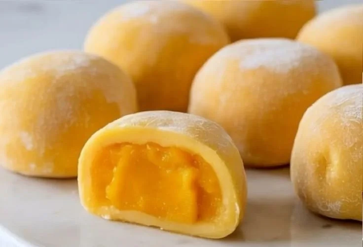 Delicious Mango Mochi dessert showcasing a chewy rice exterior and vibrant mango filling.