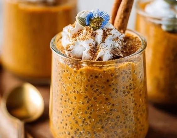 Pumpkin Chia Pudding topped with nuts and spices in a glass bowl
