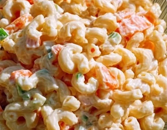 Bowl of traditional Hawaiian macaroni salad with colorful vegetables