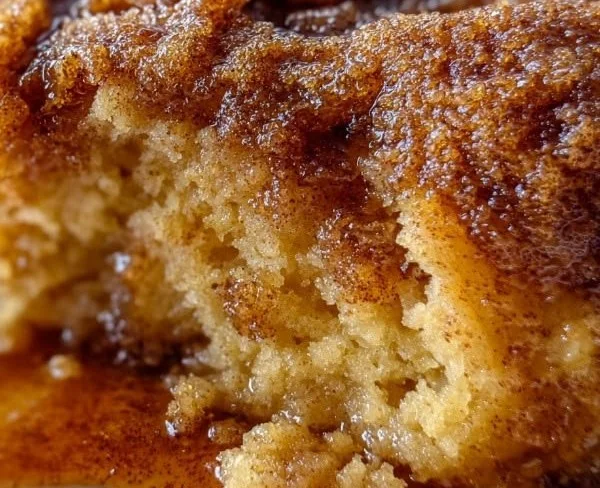 Warm gooey cinnamon snickerdoodle cobbler served in a bowl