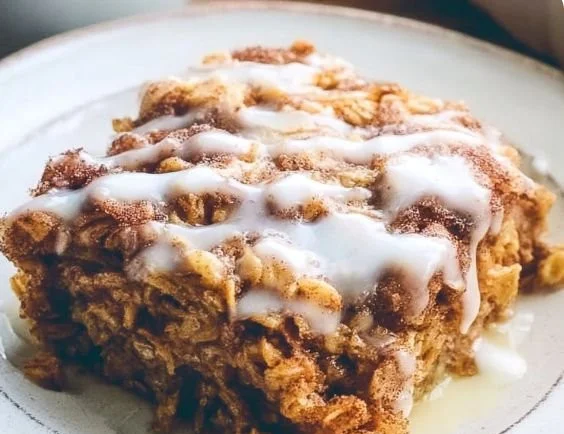 Delicious best-ever cinnamon roll baked oatmeal topped with icing