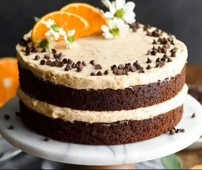 Slice of Chocolate Orange Cake with chocolate drizzle and orange zest