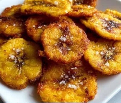 Crispy air fryer tostones served on a plate with dipping sauce