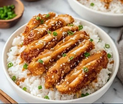 Delicious crispy peanut butter chicken served with garnishes