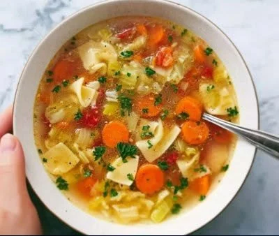 Bowl of easy cabbage soup recipe with fresh vegetables