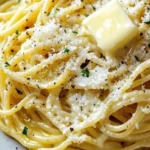 Delicious garlic butter noodles topped with Parmesan cheese served in a bowl.