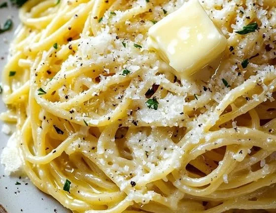 Delicious garlic butter noodles topped with Parmesan cheese served in a bowl.