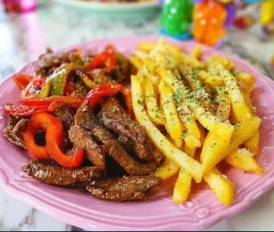 Plate of Lomo Saltado, a popular Peruvian dish with beef, stir-fried vegetables, and fries.