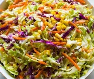 Colorful Mexican coleslaw topped with fresh cilantro and lime