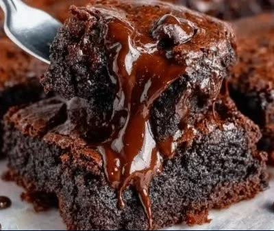 Peanut Butter Chocolate Fudge Brownies topped with chocolate drizzle.