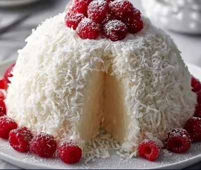 Delicious Snowball Cake topped with coconut flakes and cream frosting