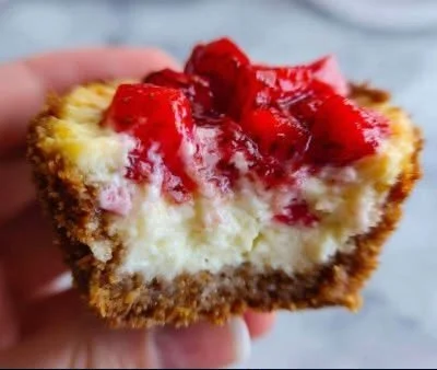 Delicious strawberry cheesecake cupcakes topped with fresh strawberries