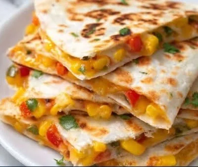 Delicious homemade vegetarian quesadillas with colorful fillings and cheese