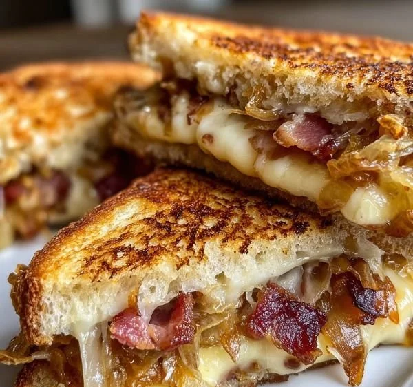 Bacon and caramelized onion grilled cheese sandwich on a plate