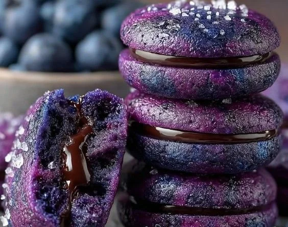 Freshly baked blueberry cookies on a cooling rack