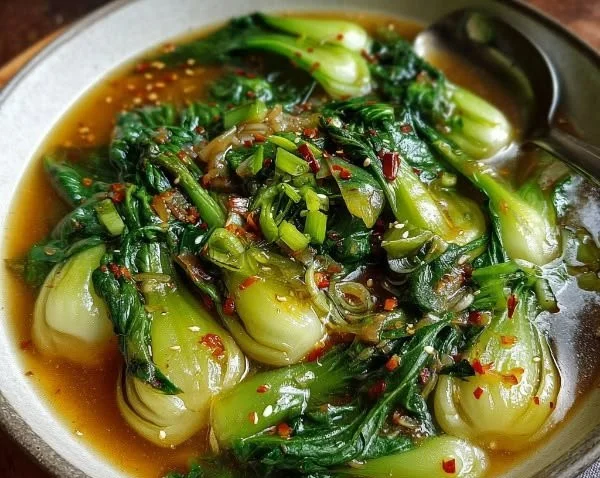 Bok Choy Garlic Ginger Soup in a bowl garnished with fresh herbs