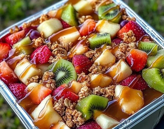 Delicious cheesecake fruit salad served in a bowl, showcasing colorful fruits and creamy texture.