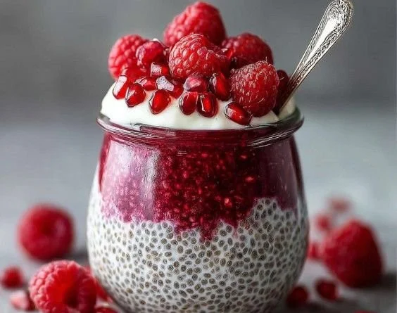 Chia seed pudding topped with raspberry and coconut for a delicious treat