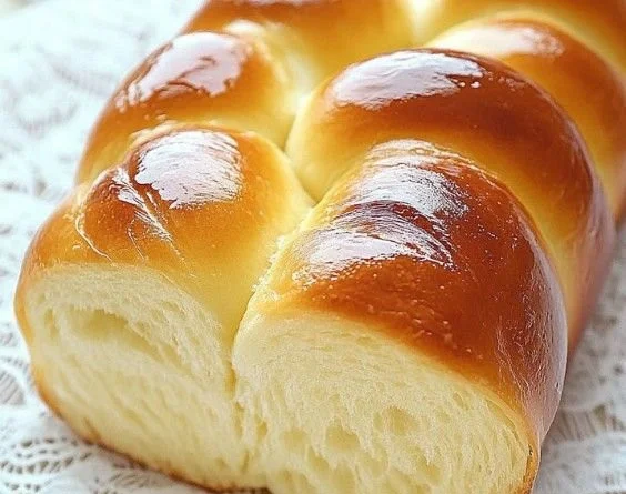 Delicious slice of homemade condensed milk bread on a wooden table