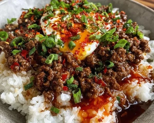 Ground Beef Bowl topped with Hot Honey, garnished with fresh herbs.