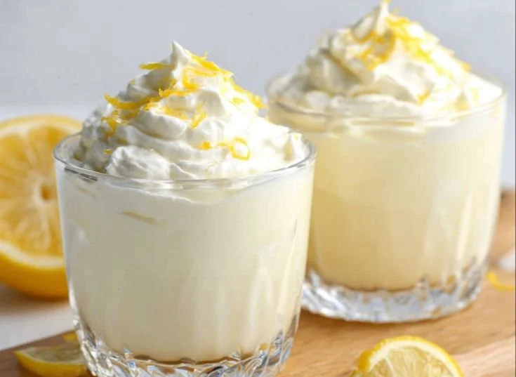 Bowl of lemon cottage cheese pudding garnished with fresh lemon slices
