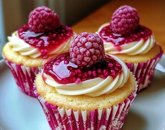 Delicious Raspberry Cheesecake Cupcakes topped with fresh raspberries