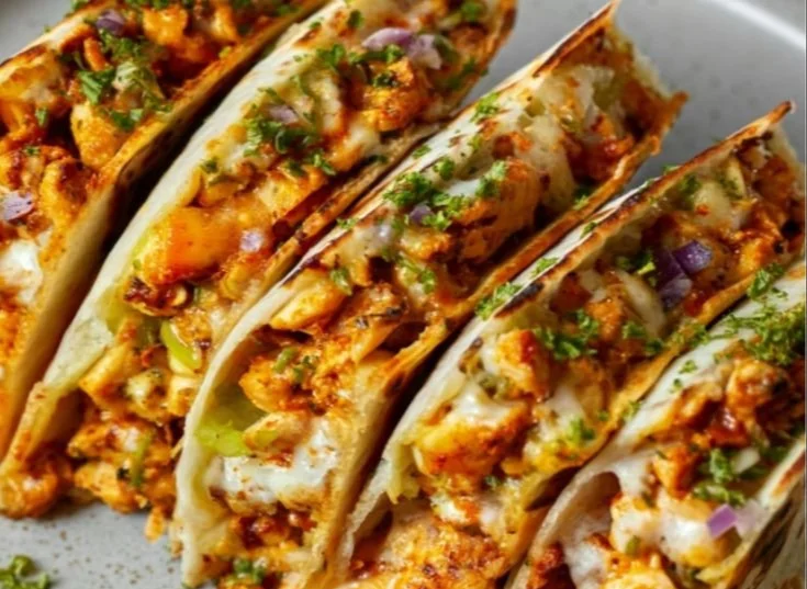 Homemade Taco Bell quesadilla on a plate with melted cheese and toppings.